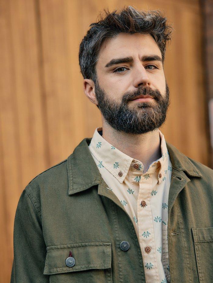 man with beard wearing shirt and jacket